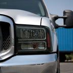 1999-2004 Ford F-250/F-350/F-450/F-550/2000-2004 Excursion Euro Factory Style Headlights with Dual LED C-Bar & Amber Reflectors (Jet Black Housing/Smoked Lens)